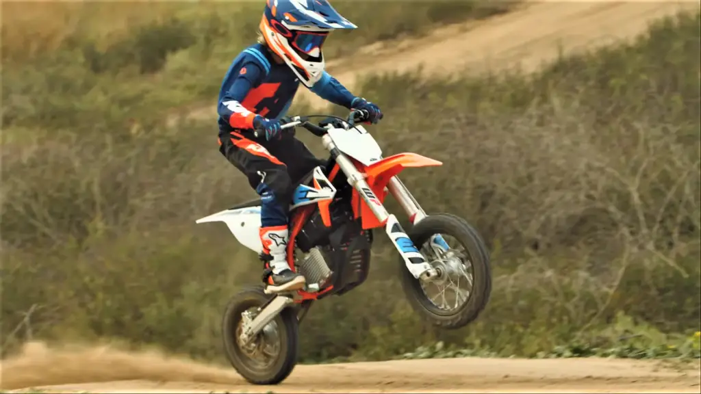 KTM-SX-E5-Kids-electric-motocross-dirt-bike-action-shot-wheelie