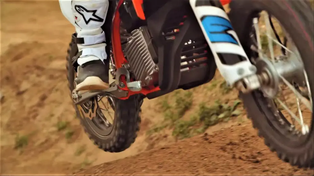 KTM-SX-E5-Kids-electric-motocross-dirt-bike-action-shot-with-motor-compartment-view